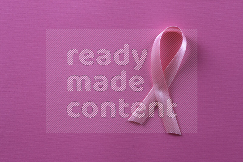 Cancer awareness ribbons on pink background