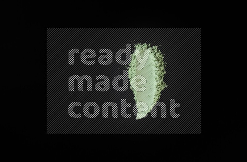 Green powder smears on black background