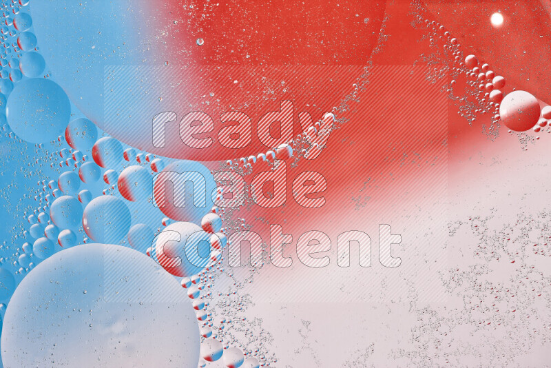 Close-ups of abstract oil bubbles on water surface in shades of red, white and blue