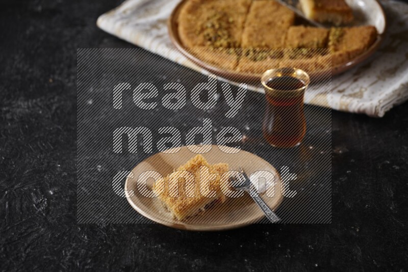 konafa with tea in a dark setup