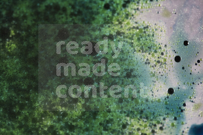 Close-ups of abstract green and blue watercolor drops on oil Surface on white background