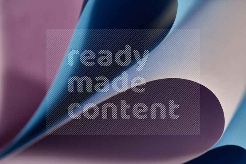 An abstract art showing purple and blue paper sheets arranged in an overlapping curves