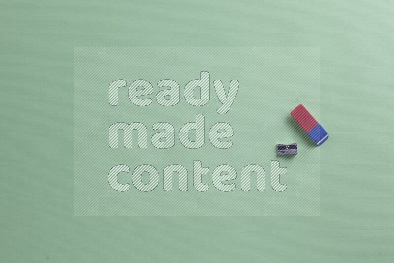 Different school supplies on green background