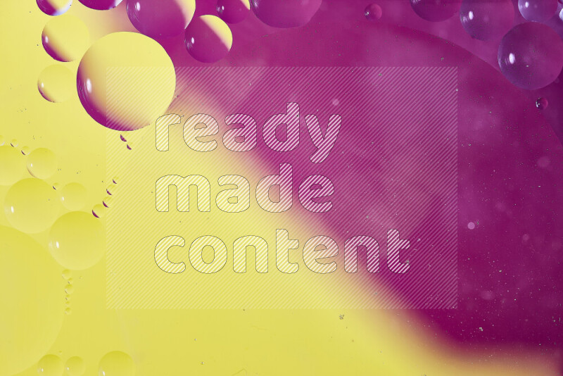 Close-ups of abstract oil bubbles on water surface in shades of yellow and pink