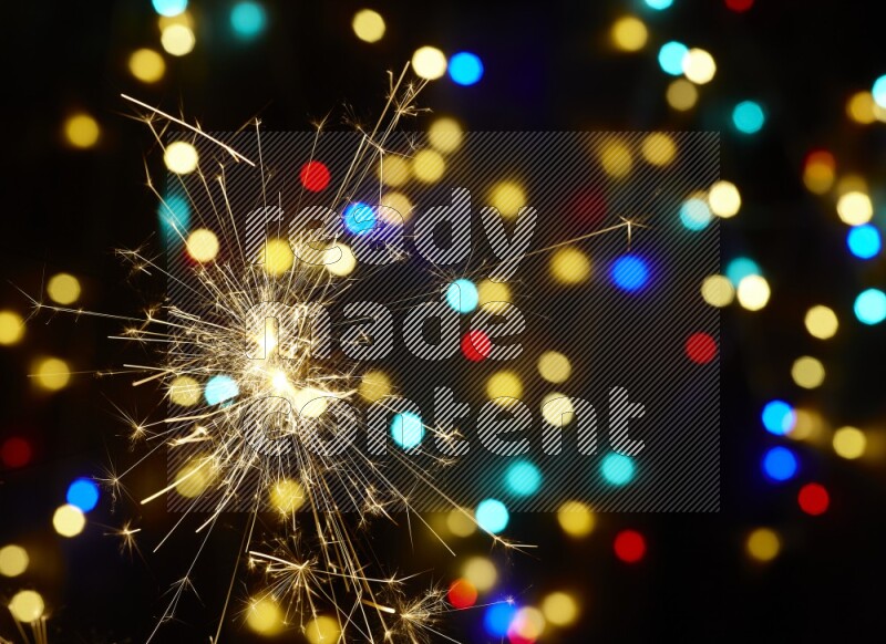 Sparkler candles with multicolored light bokeh background