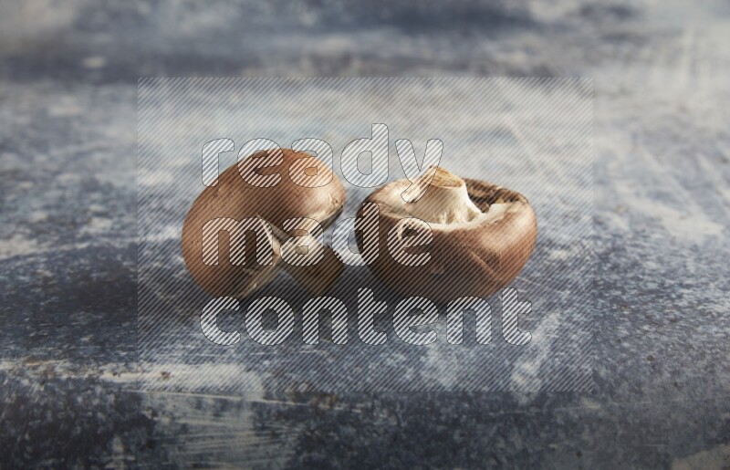 45 degre cremini  mushrooms on a textured rustic blue background