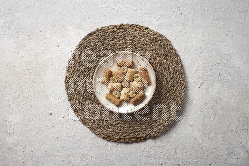 Oriental sweets in pottery plates in a light setup