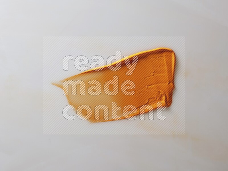 An orange straight painting knife stroke on white background