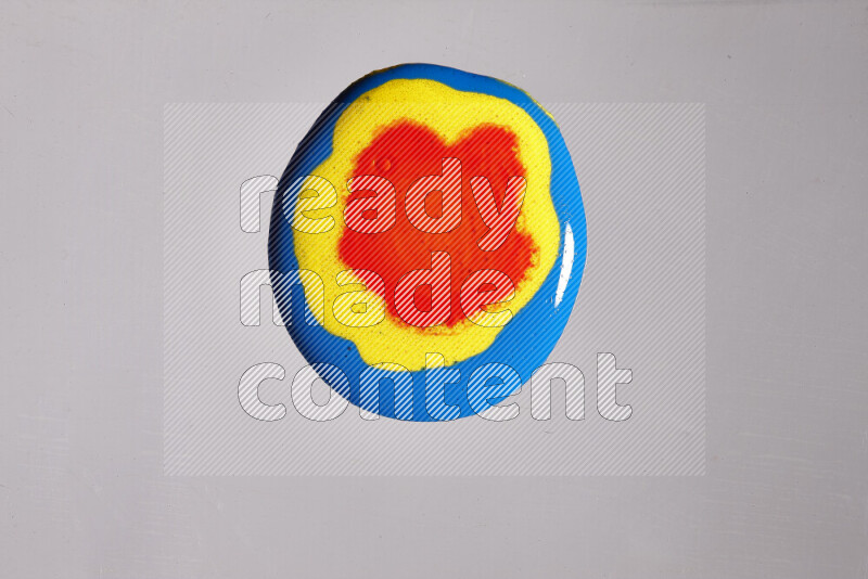 Close-ups of assorted colors blending on a grey background