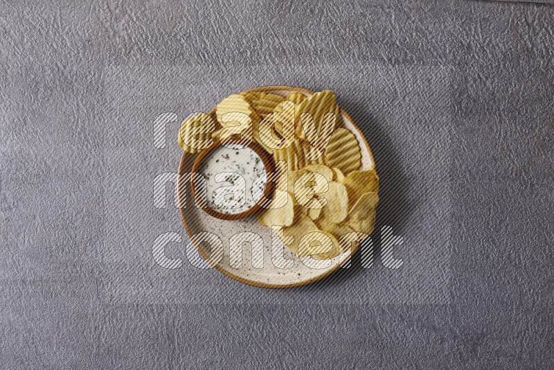Assorted snacks in pottery bowls on grey background