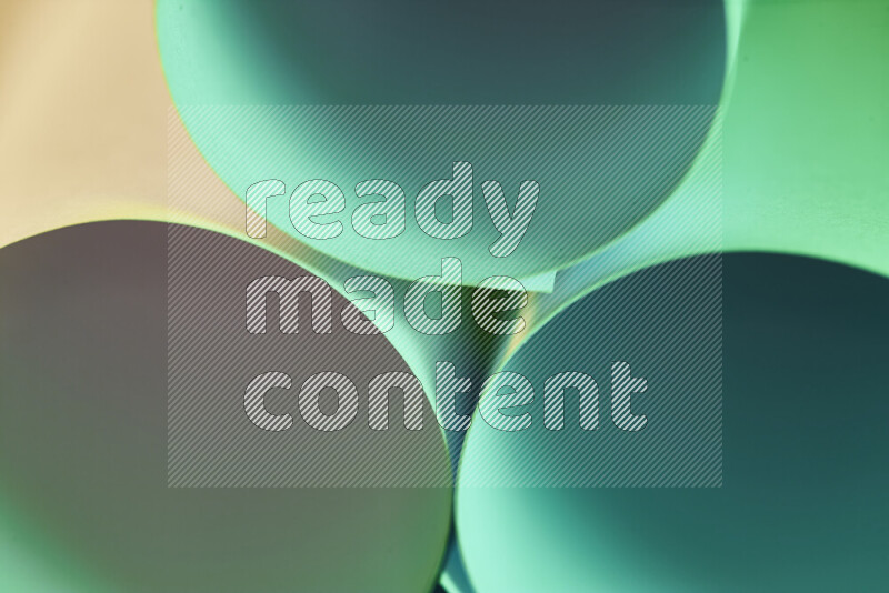 The image shows an abstract paper art with circular shapes in varying shades of green and warm tones