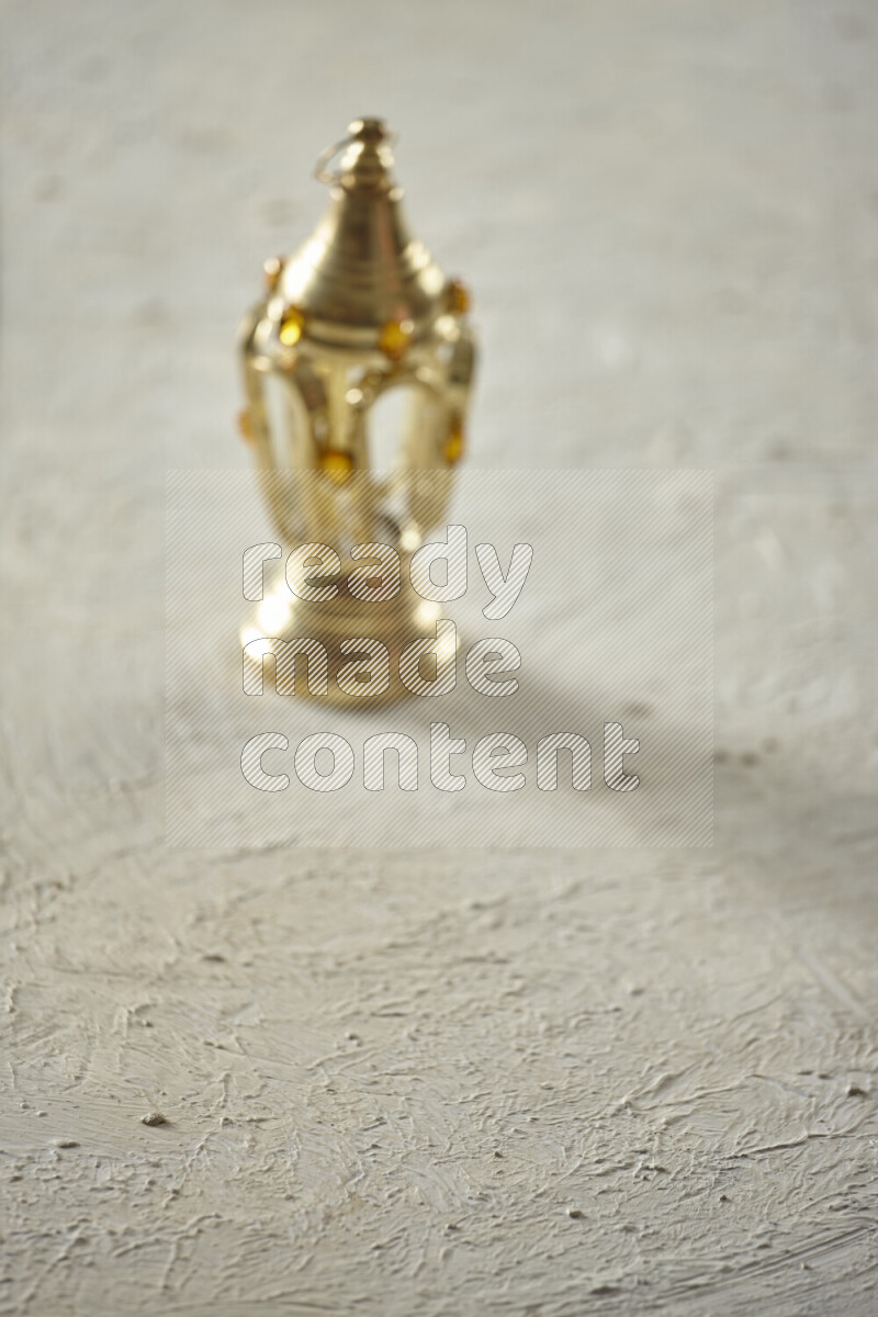 A lantern placed on a textured white background