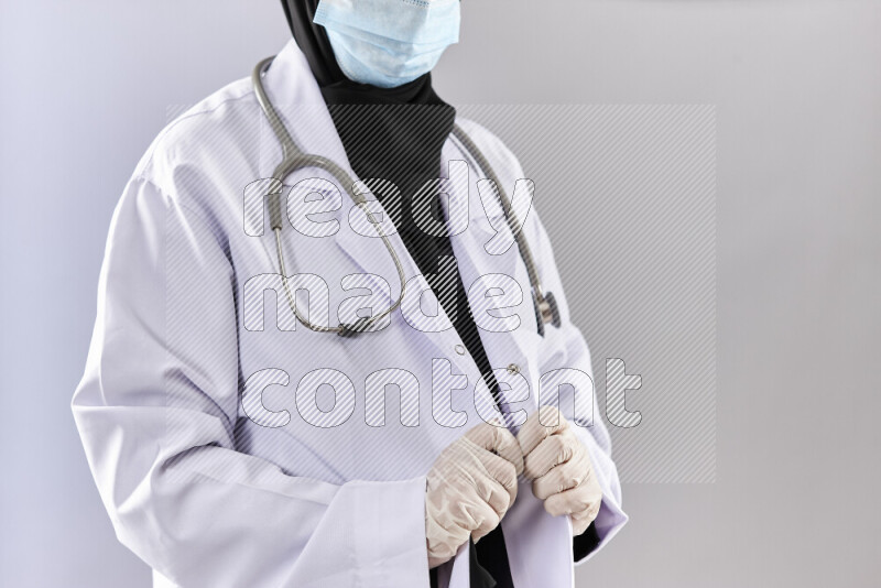Female doctor wearing an abaya and medical attire in different positions