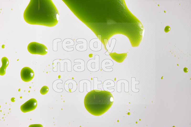 Close-ups of abstract green paint droplets on the surface