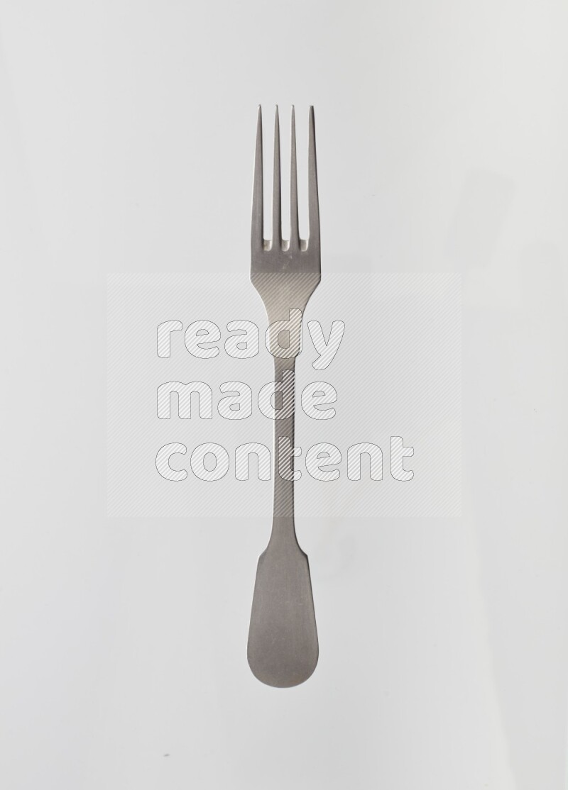 Silver stainless steel fork on white background