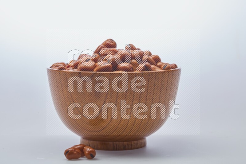 Close up shot of cooked fava beans (foul) in a container on white background