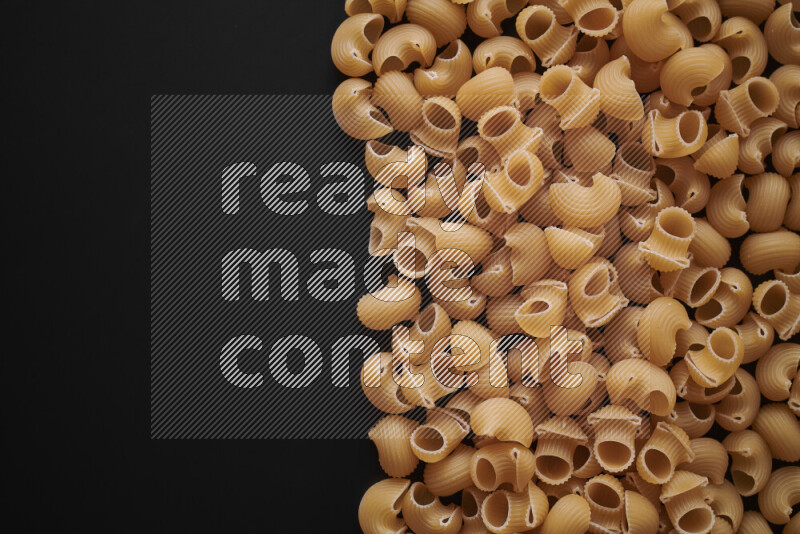 Different pasta types on black background
