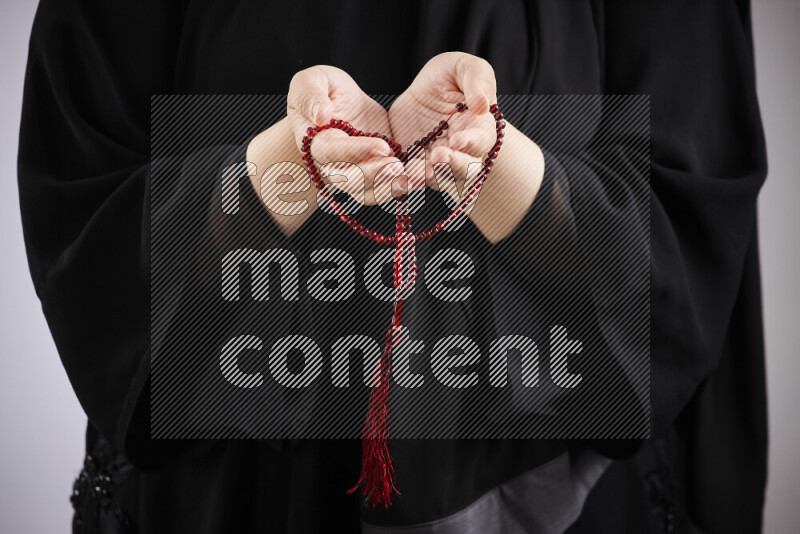 Woman hands holding praying beads (sebha) in different positions