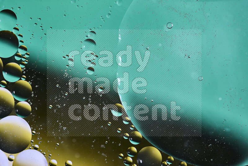 Close-ups of abstract oil bubbles on water surface in shades of green, black and yellow