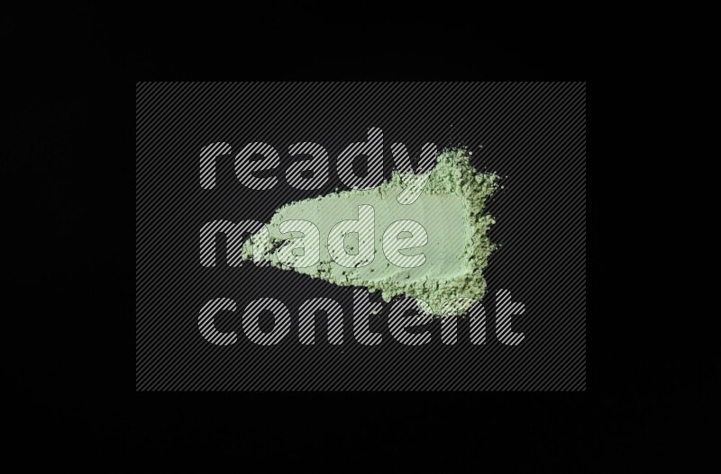 Green powder smears on black background
