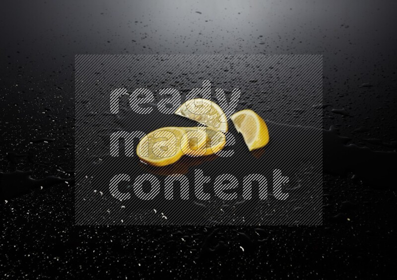 Lemon slices with water drops, and droplets on black background