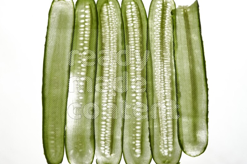 Cucumber slices on illuminated white background