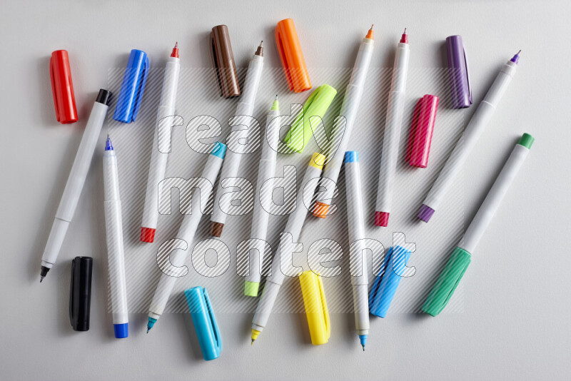 An arrangement of coloring pens in different colors on grey background