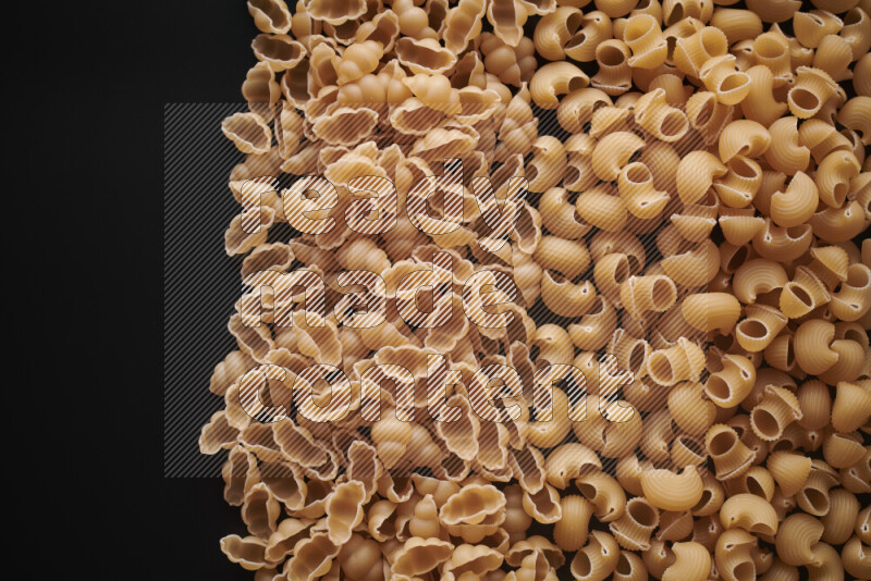 Different pasta types on black background