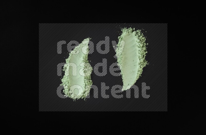 Green powder smears on black background