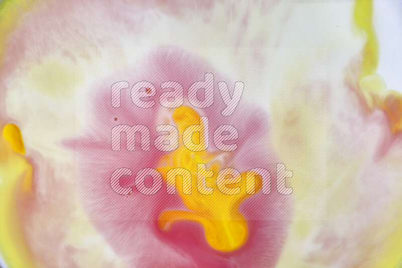 A close-up of abstract swirling patterns in yellow, red and white