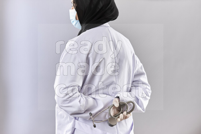 Female doctor wearing an abaya and medical attire in different positions