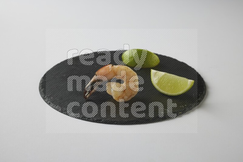 one  grilled shrimp  on a black slate direct  on a white back ground