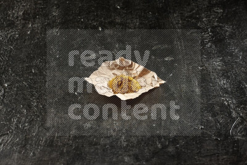 بودرة الكركم  في قطعة من الورق على خلفية سوداء