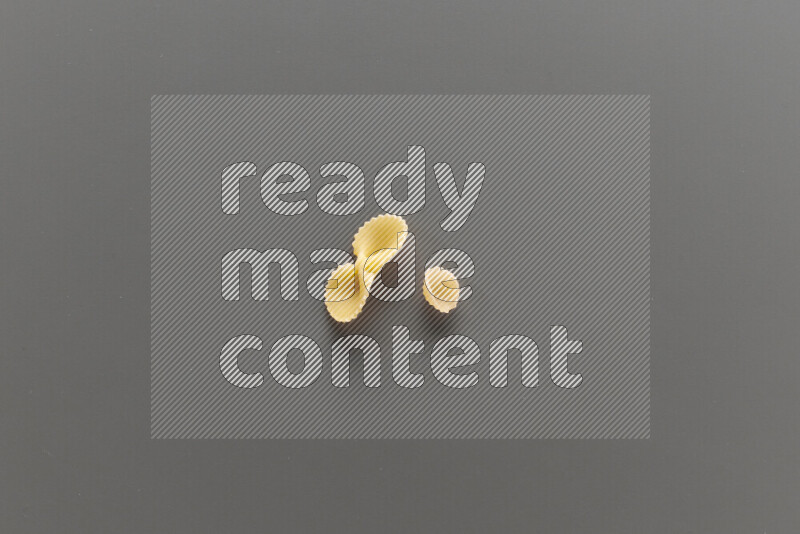 Fiocchi pasta with other types of pasta on grey background