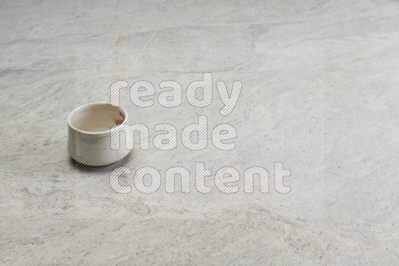 A white pottery bowl on grey marble background