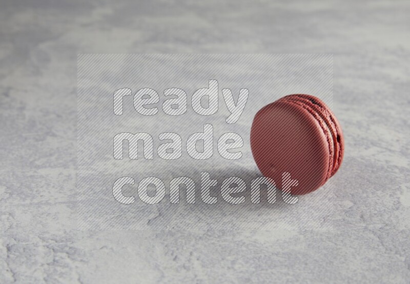45º Shot of Red Velvet macaron on white  marble background
