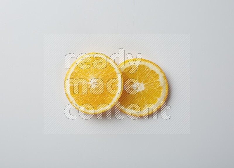 Two orange slices on white background