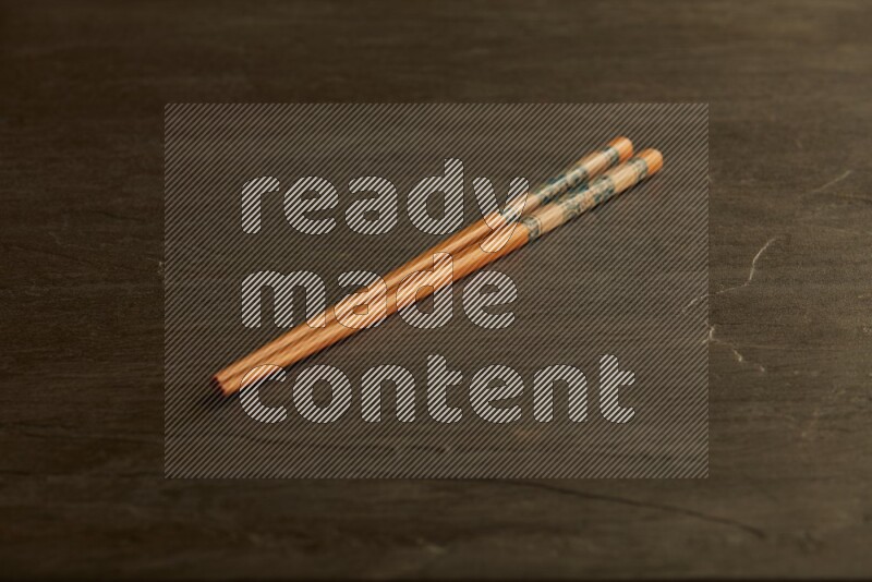 wooden chopsticks on black slate background