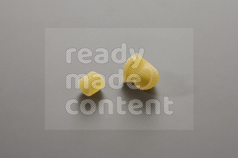 Big rings pasta with other types of pasta on grey background