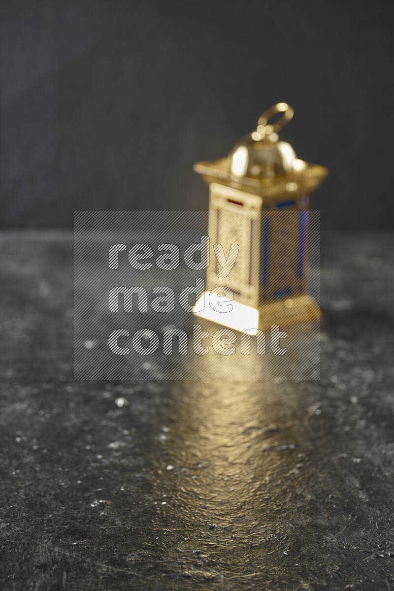 A lantern placed on a textured black background