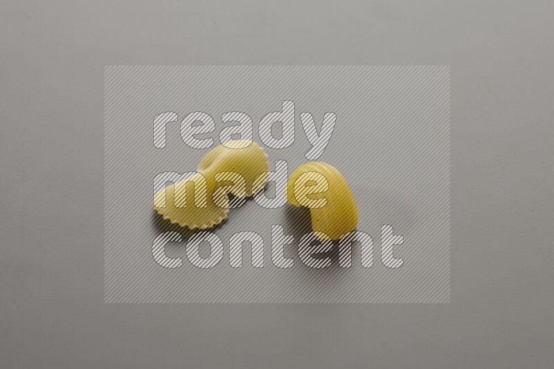 Fiocchi pasta with other types of pasta on grey background