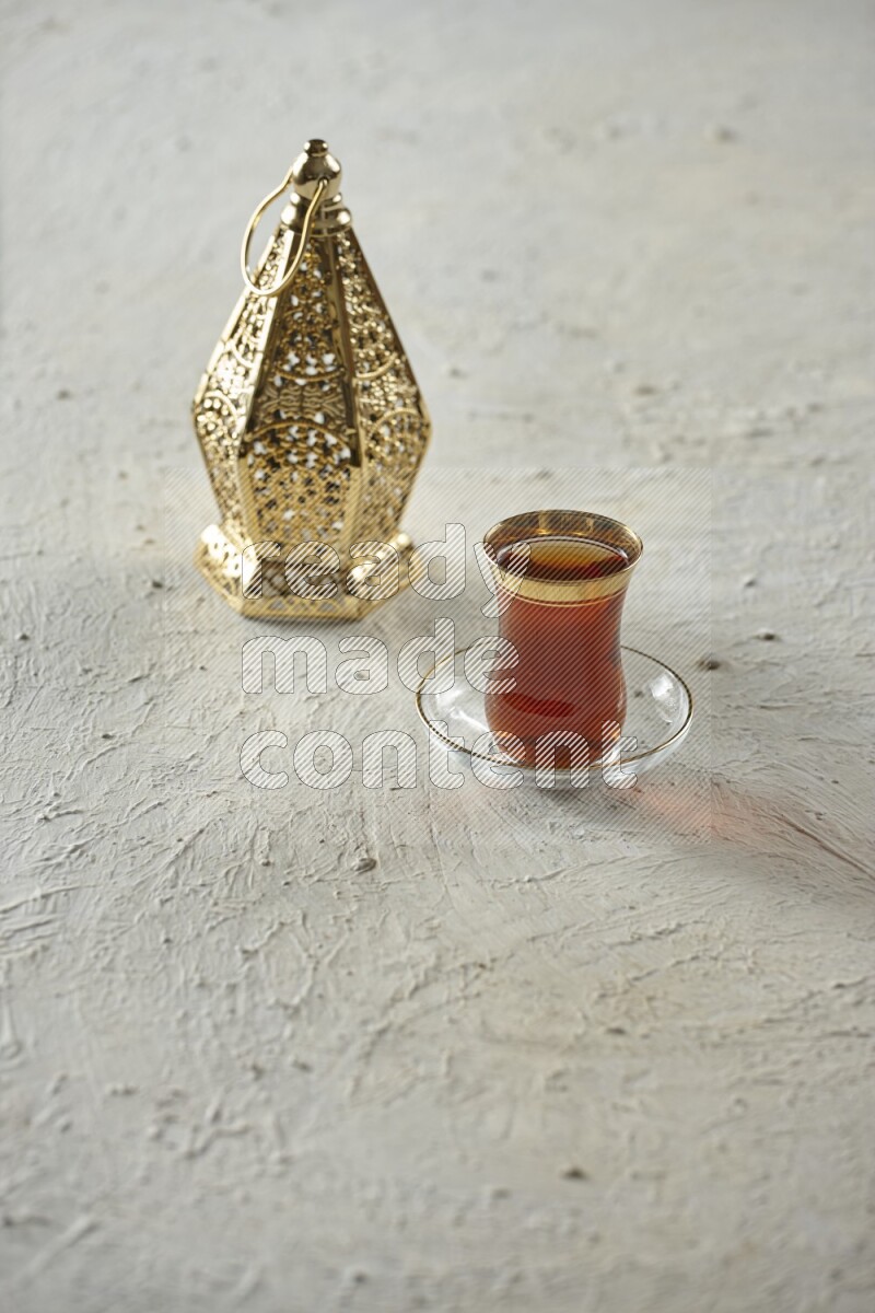 A golden lantern with different drinks, dates, nuts, prayer beads and quran on textured white background