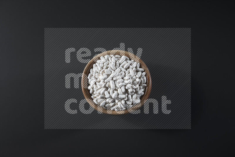 Snacks in a wooden bowl on grey background