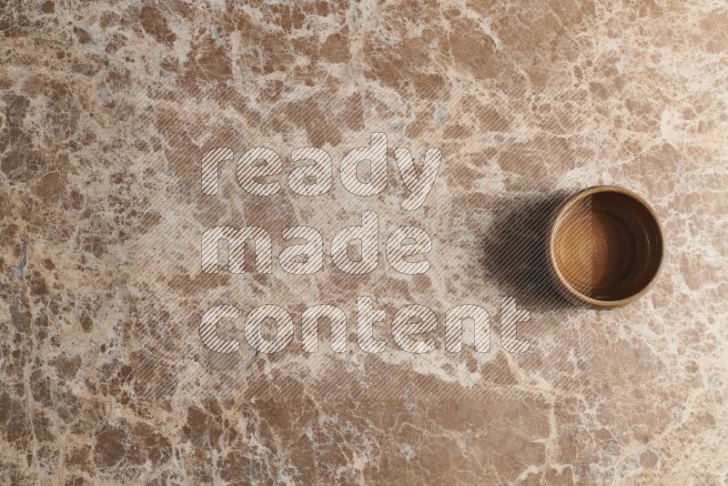 Top View Shot Of A Brown Pottery bowl On beige Marble Flooring