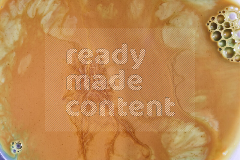 A close-up of abstract different swirling patterns in orange