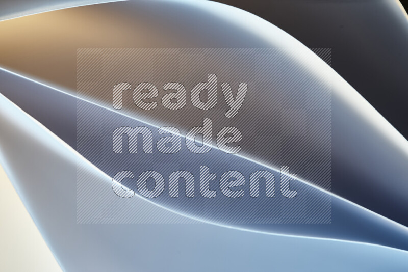 This image showcases an abstract paper art composition with paper curves in blue and yellow gradients created by colored light