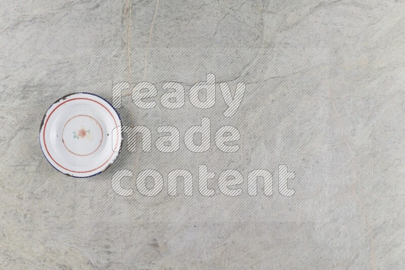 A vintage metal plate on grey marble background