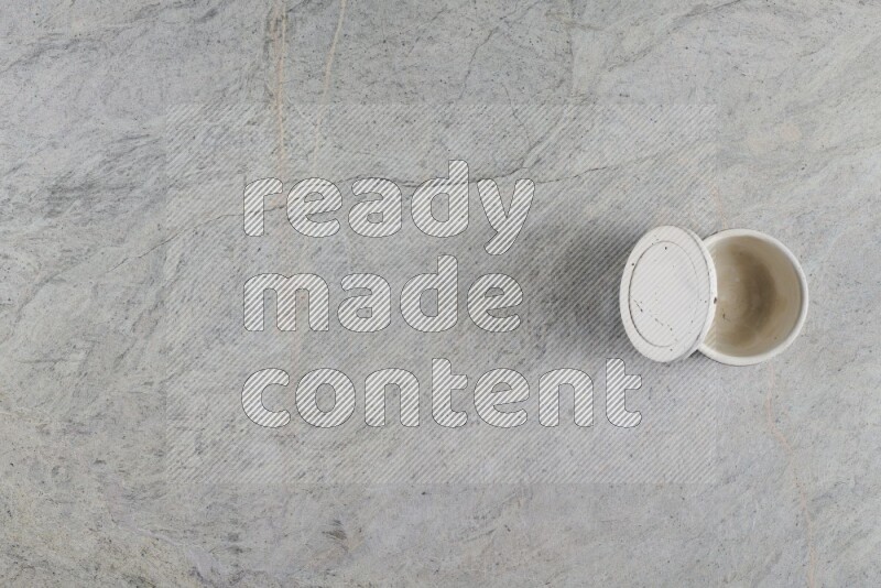 A multicolored pottery Cup on grey marble background