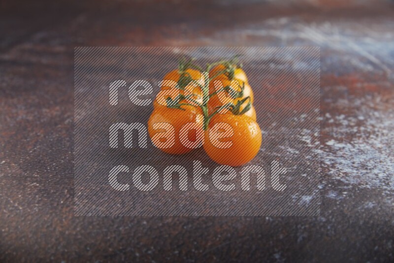 Orange cherry tomato vein on reddish rustic metal background 45 degree