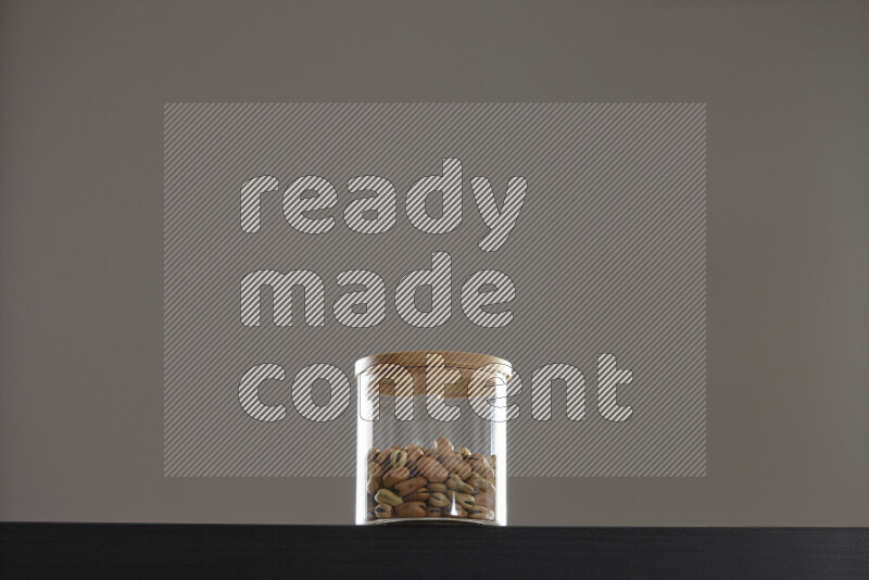 Fava beans in a glass jar on black background